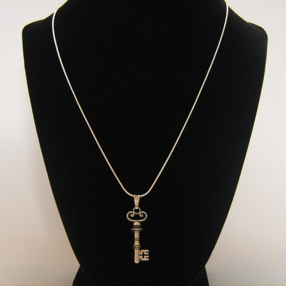 Ornate silver skeleton key pendant